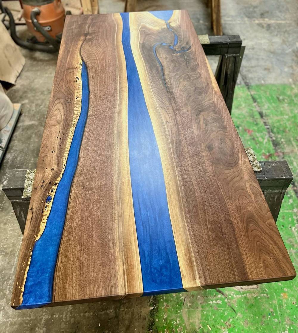 Overhead view of the blue epoxy river running between two walnut slabs