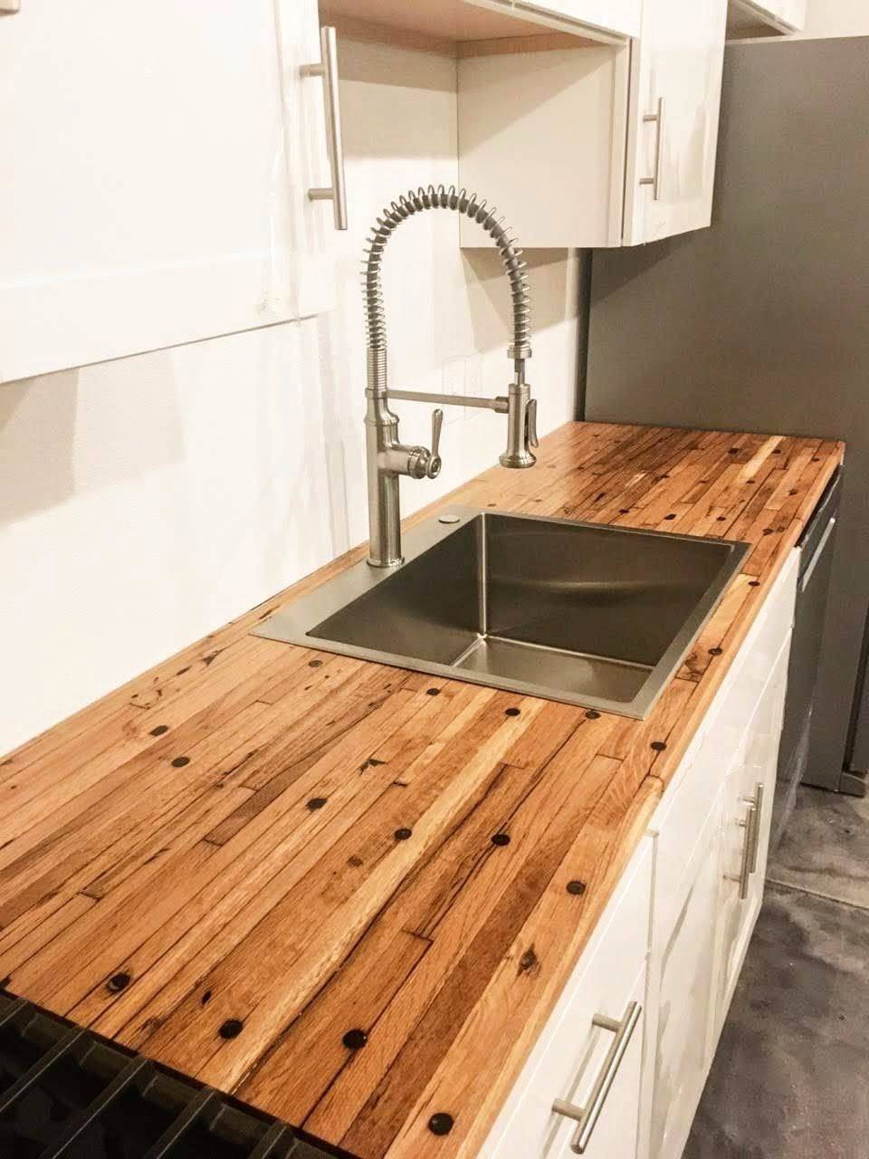 Boxcar flooring countertop around an undermount kitchen sink, dowel plugs and mixed board tones running the length of the run