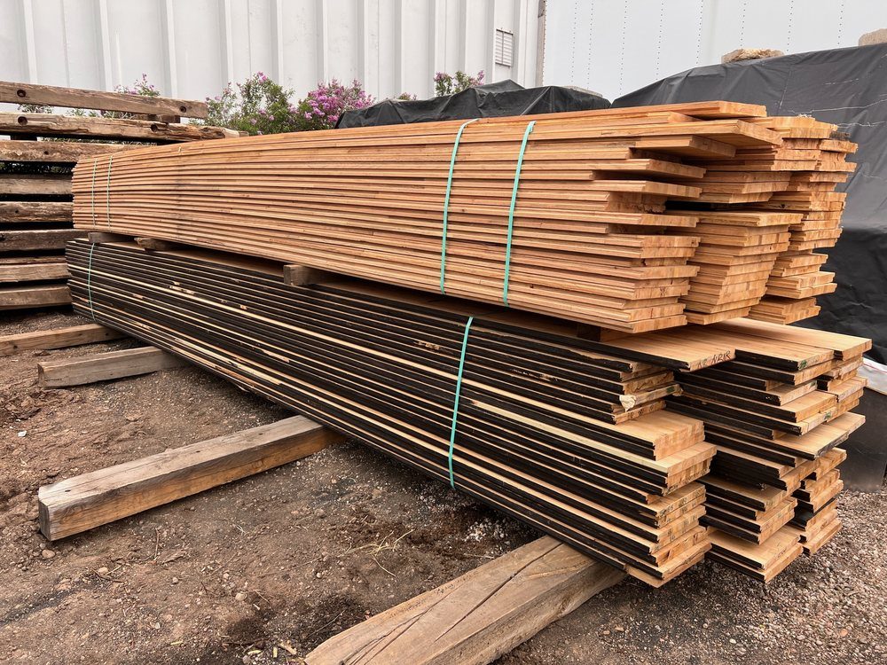Banded bundles of reclaimed semi-trailer decking stacked in the Denver yard