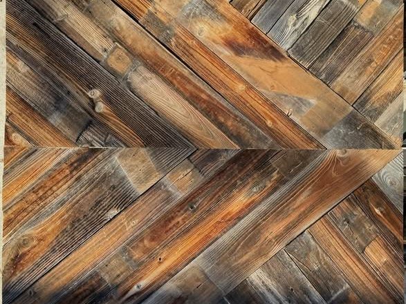 Barnwood panels laid in a herringbone pattern across a feature wall
