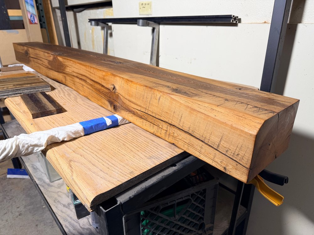 Finished reclaimed mantel on the bench, oiled so the grain and figure come up, ends squared