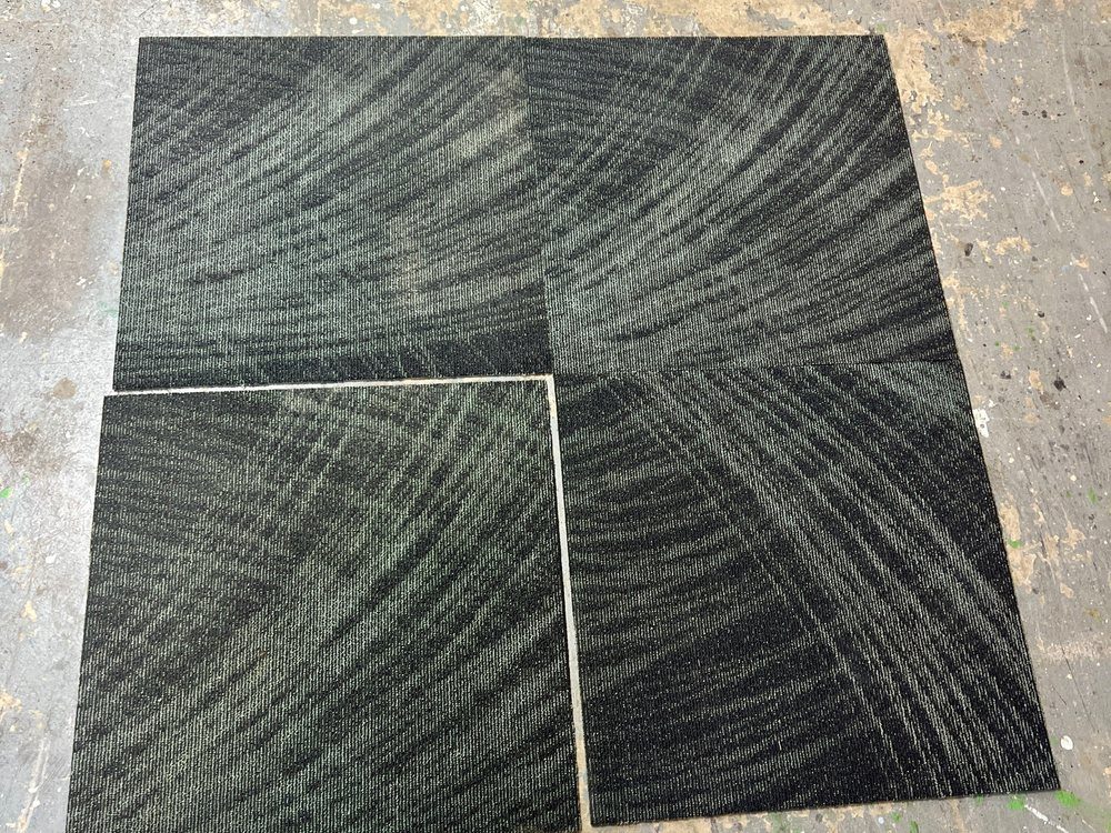 Dark green commercial carpet tiles laid corner to corner