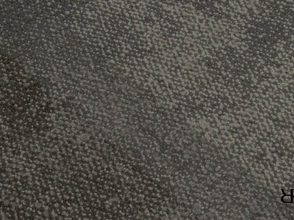 Close texture of a brown commercial carpet tile with the pile visible