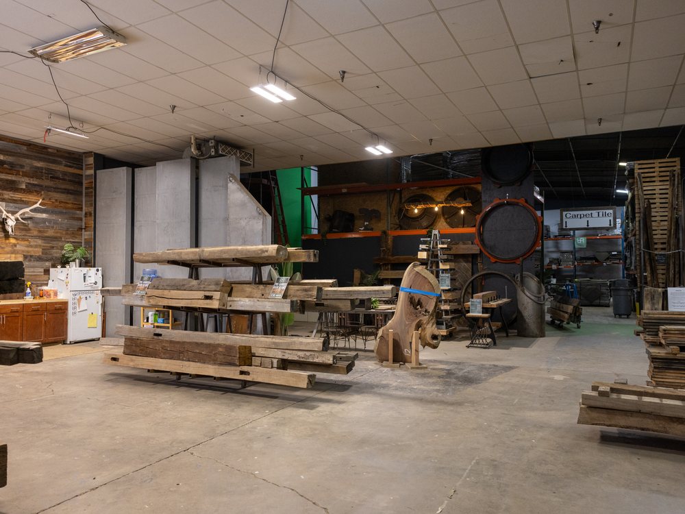 The main warehouse floor, benches and racked material running the length of the building